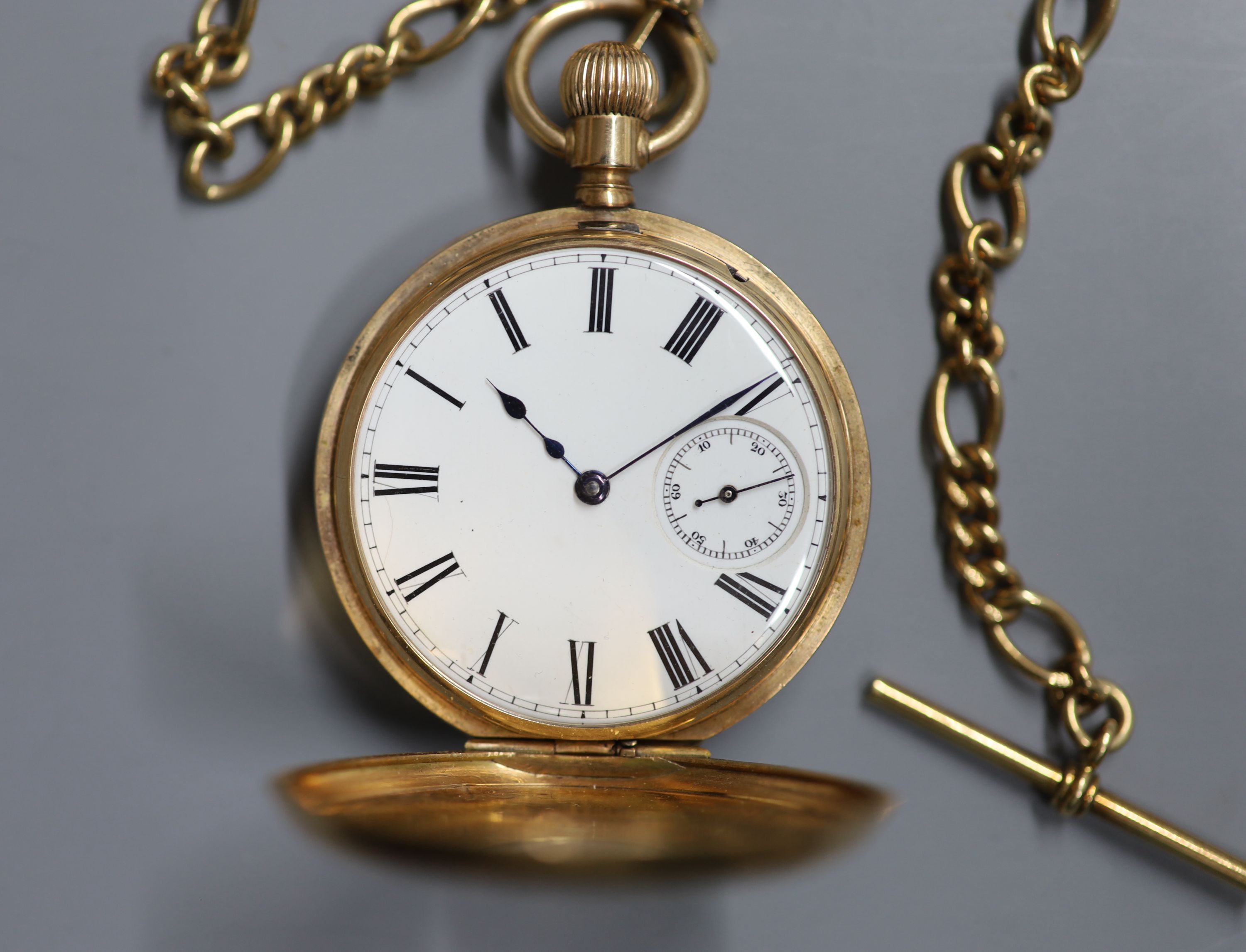 An American Waltham 10ct yellow metal half hunter keyless pocket watch, on a 9ct gold albert,